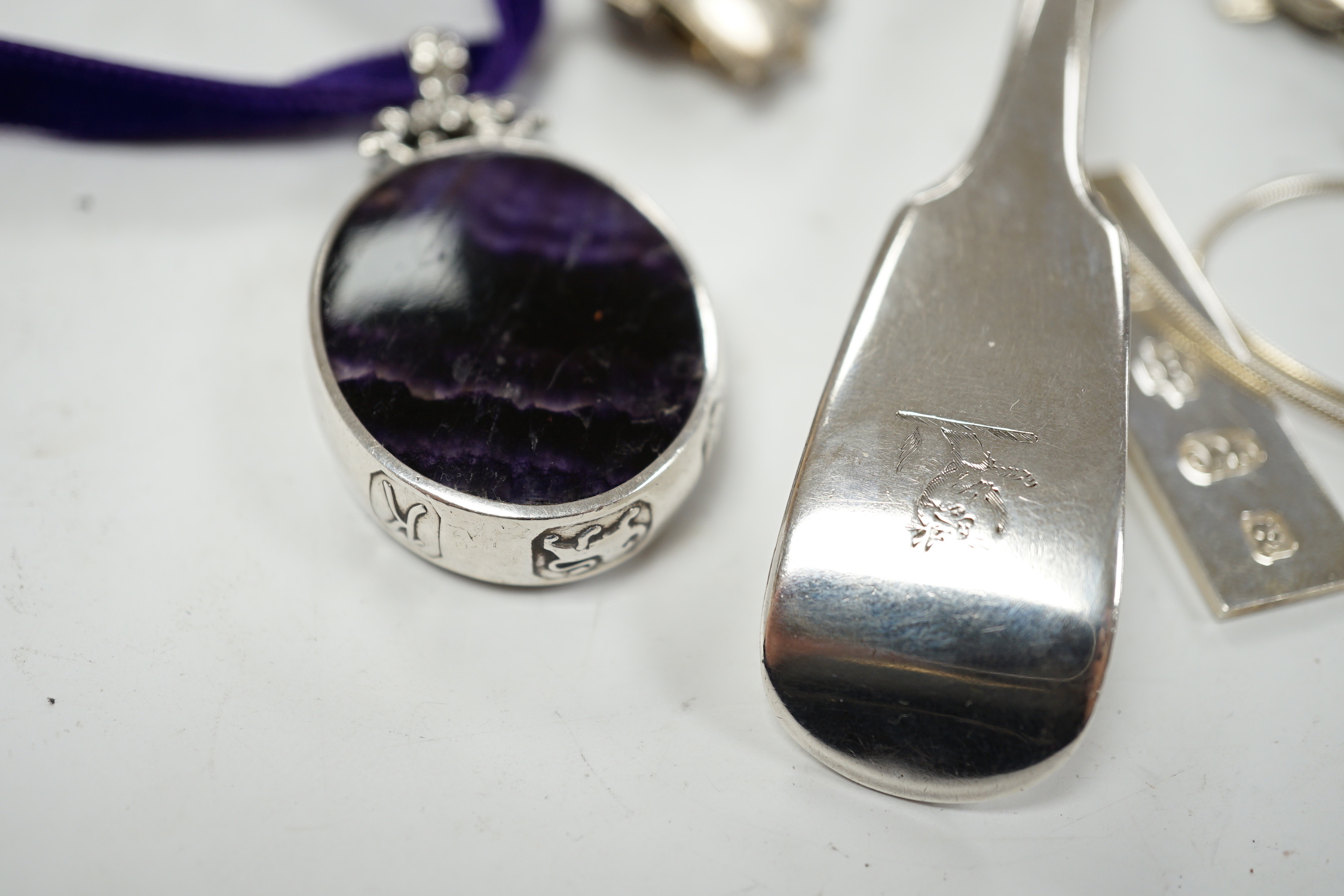 A modern silver mounted blue john pendant, by David Scott Walker, 54mm, together with other jewellery including silver ingot pendant, charm bracelet etc. and a George IV silver sifter spoon, William Eaton, London, 1829.